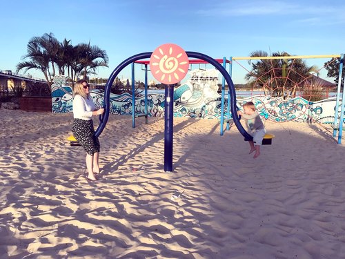 mother and son playing on play equiptment